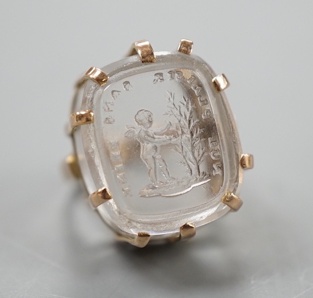 A modern 9ct gold ring, set with earlier oval rock crystal intaglio, the matrix carved with crest and the motto 'Nul Plaisir Sans Peine' size F, gross weight 10.7 grams.